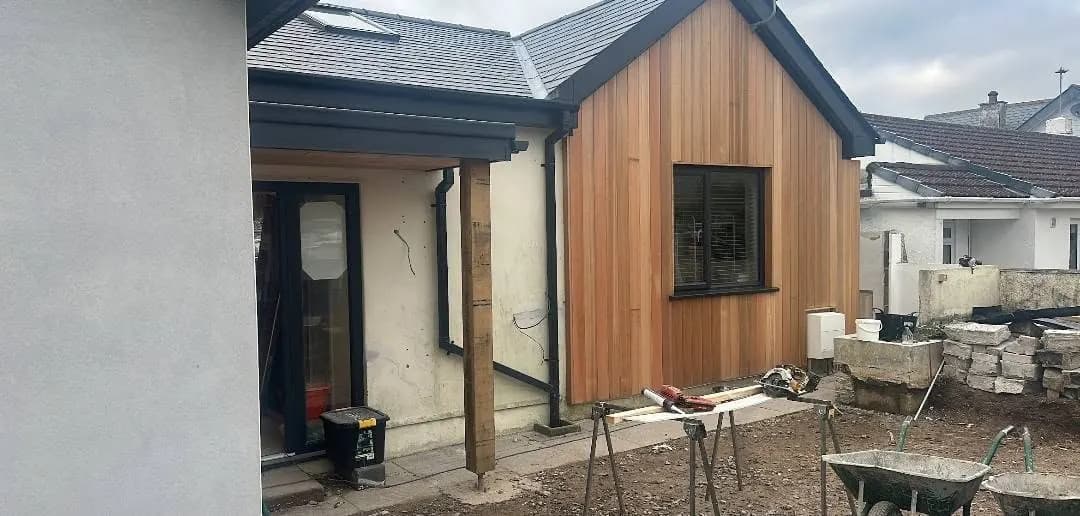 Cedar-clad extension and new porch nearing completion — a real Crews Carpentry job