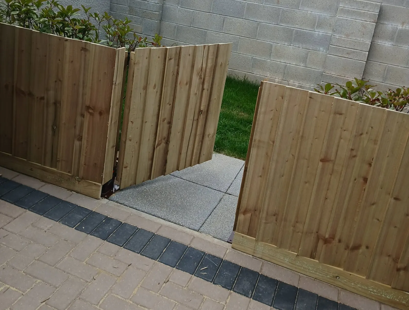New timber close-board fencing with a matching gate and gravel path